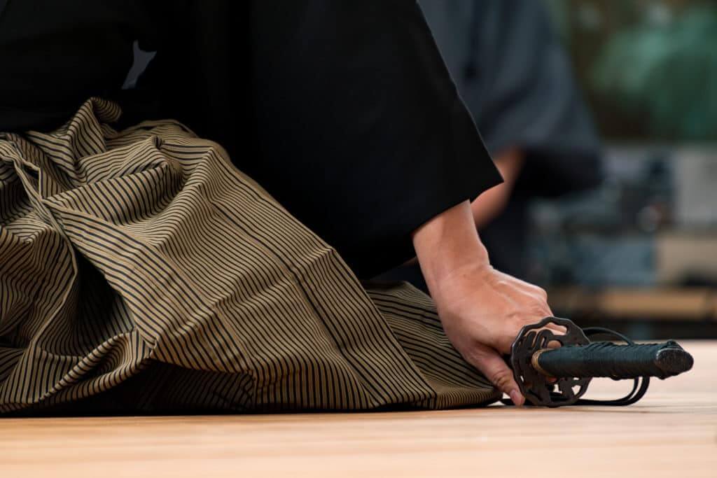 Samurai kneeling with katana